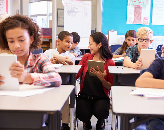 Teacher assisting students